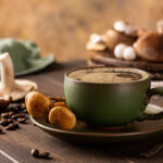 Best mushroom coffee 2025 .Mushroom coffee in green cup on wooden background. New Superfood trendy healthy concept with copy space, selective focus.